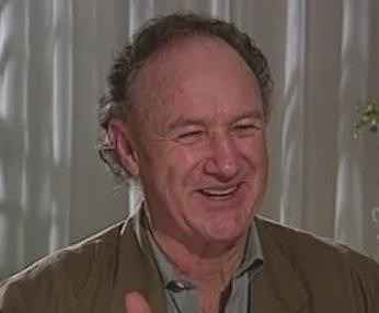 Gene Hackman w dynamicznej roli filmowej, ukazujący intensywność i determinację postaci.