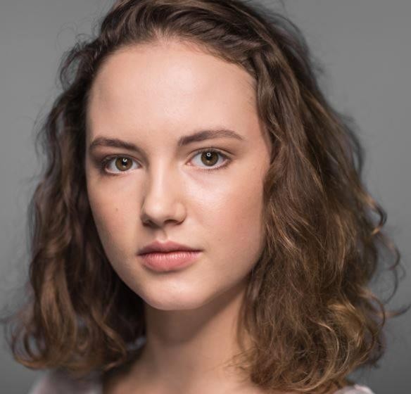 Martyna Byczkowska na planie filmowym, skupiona na roli, w tle rozmyte elementy scenografii.