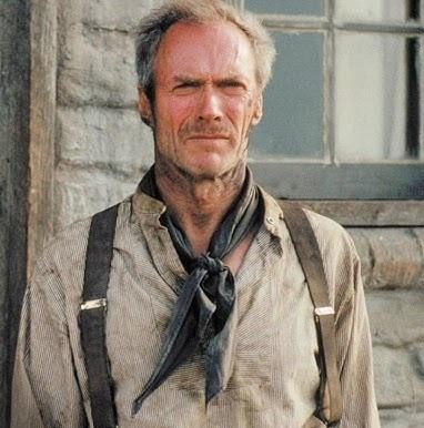 Clint Eastwood w ikonicznej roli rewolwerowca z westernu, z charakterystycznym kapeluszem i intensywnym spojrzeniem, na tle pustynnego krajobrazu.
